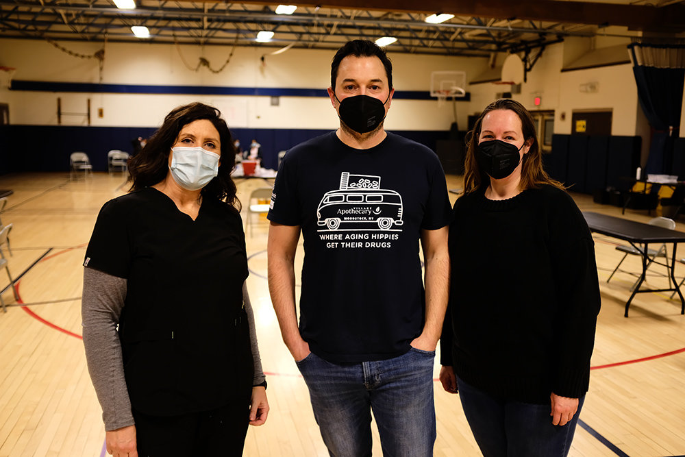 Dr. Neal Smoller is flanked by LPN Anne Marie Hoffstatter (L) and Clinical Assistant Catherine Rohr at a vaccine clinic that was held recently at the Highland Elementary School.